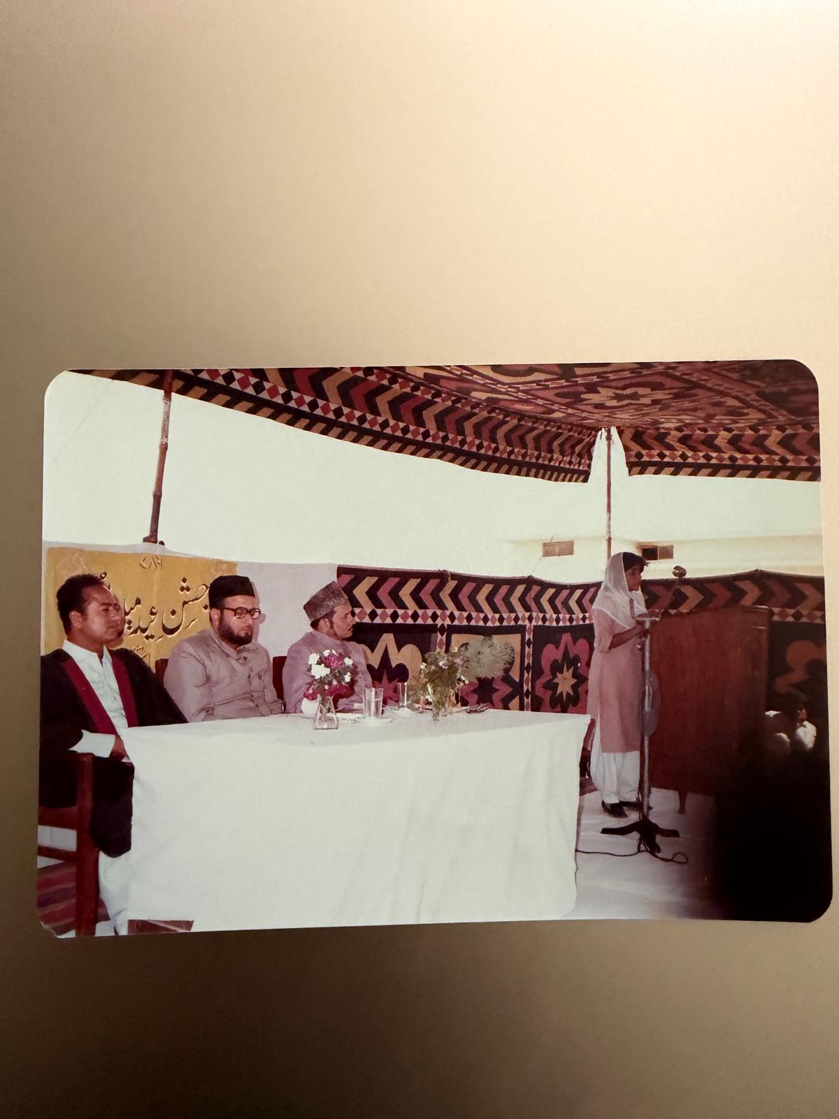 A gathering under a decorated tent at a Jashn-e-Eid Milad celebration
