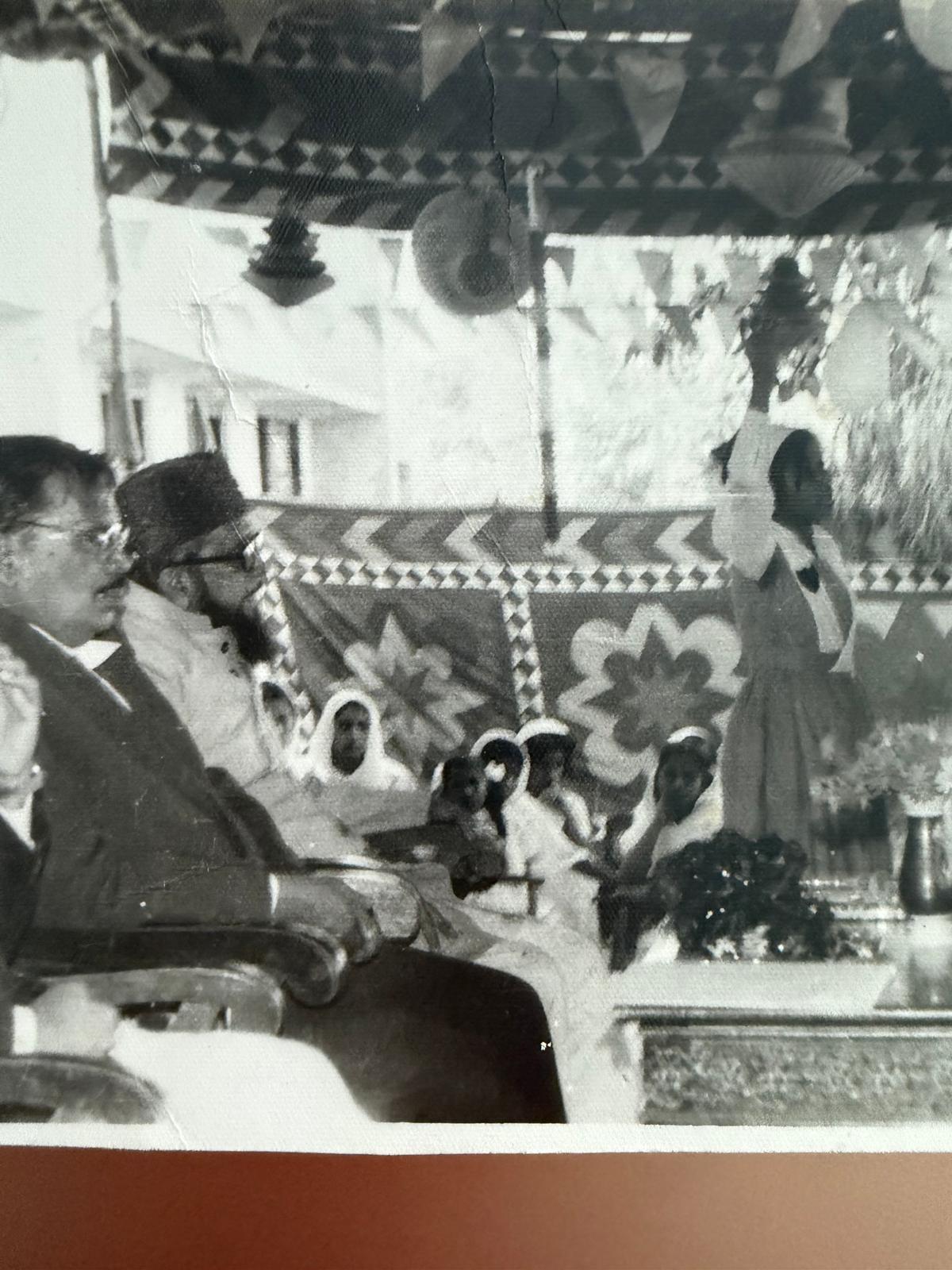 A gathering scene with decorated backdrop and audience